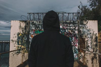 Man standing by fence