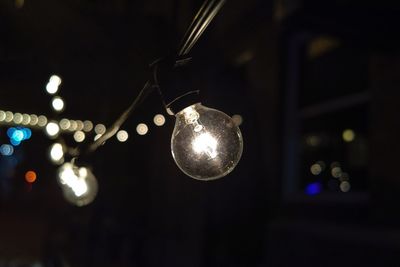 Illuminated light bulbs at night