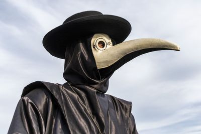 Close-up of person wearing spooky costume against sky