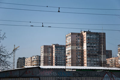 Low angle view of buildings against clear blue sky