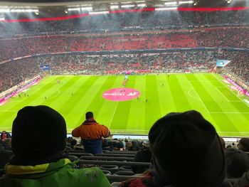 Rear view of people looking at soccer field