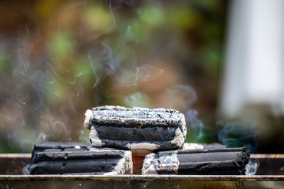 Close-up of charcoal stack on metal