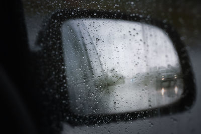 Close-up of wet glass window in rainy season