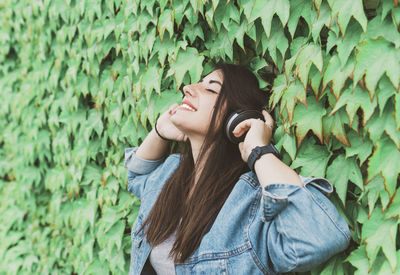 Full length of young woman standing on leaves