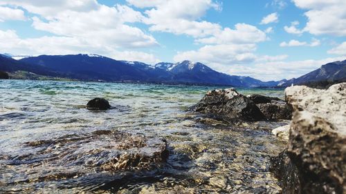 Scenic view of sea and mountains against sky