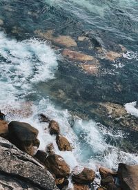 High angle view of rocks in sea