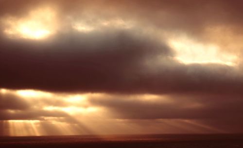 Scenic view of dramatic sky over sea during sunset