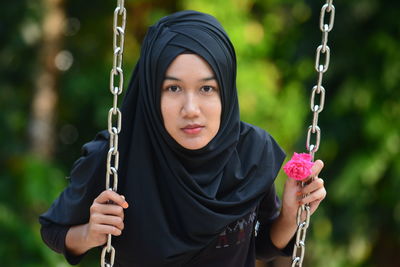 Close-up portrait of young woman with swing