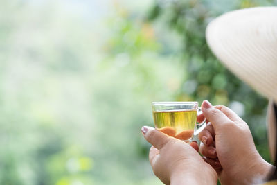 Close-up of hand holding drinking glass