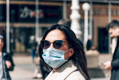 Portrait of woman with face mask in city. covid, corona, epidemic, virus, protective mask.