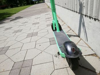 High angle view of bicycle on footpath during sunny day