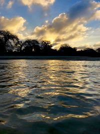 Scenic view of lake against sky during sunset