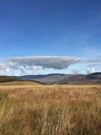 View of countryside landscape against cloudy sky