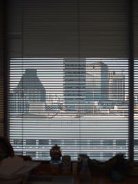 People walking on building seen through glass window