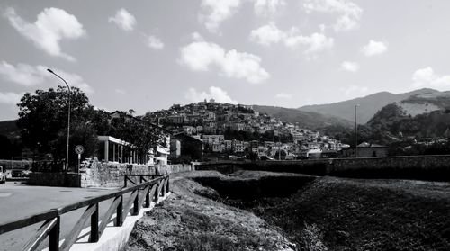 Scenic view of buildings and mountains against sky