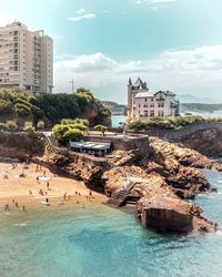 View of buildings by sea in city