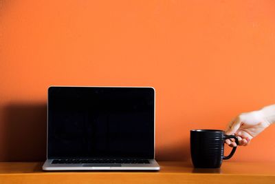 Close-up of man using laptop