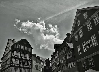 Low angle view of building against cloudy sky