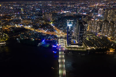 High angle view of illuminated city buildings at night