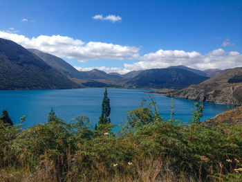 Scenic view of lake and mountains against sky