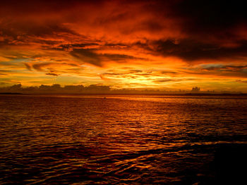 Scenic view of sea against orange sky