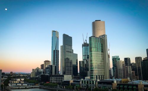 Modern buildings in city against clear sky