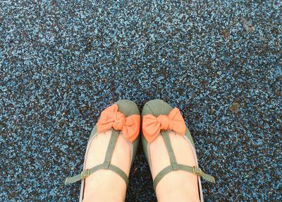 Low section of woman standing on tiled floor