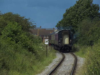 Train on railroad track against sky