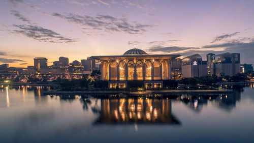 Reflection of buildings in water at sunset