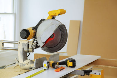 Close-up of work tools on table at carpentry workshop