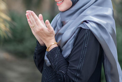 Low section of woman standing on leaf