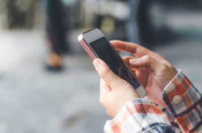 Midsection of man using mobile phone