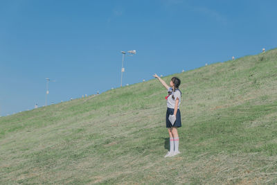 Full length of man playing on field against sky