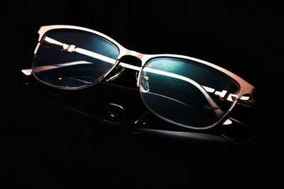 Close-up of sunglasses against black background