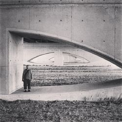 Full length of woman standing by railing