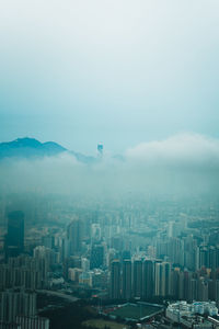 Aerial view of buildings in city against sky