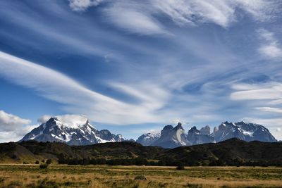 Scenic view of mountains against cloudy sky