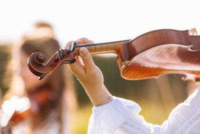 Cropped image of man playing violin