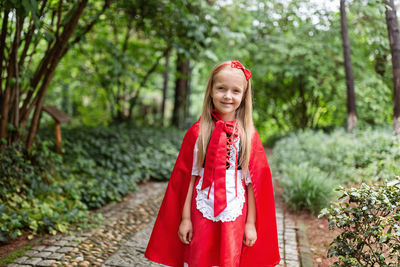 Portrait of smiling girl wearing costume standing at park