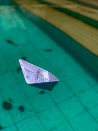 High angle view of paper boat floating on water