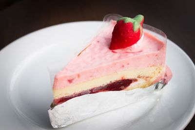 Close-up of strawberry cake served on white plate