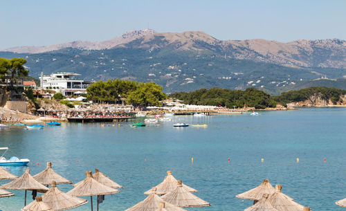 Scenic view of sea by buildings against sky