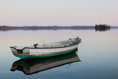 Boat moored in lake against clear sky