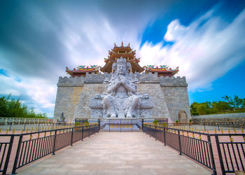 Statue of temple against cloudy sky