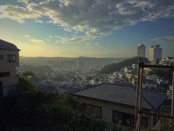 Cityscape against cloudy sky