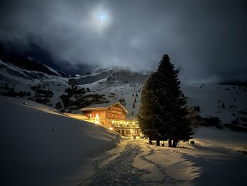 Scenic view of snowcapped mountains against sky during sunset