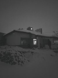 House on sand dunes against clear sky