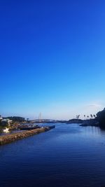 View of bridge over river against blue sky