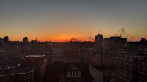 High angle view of buildings against clear sky at sunset