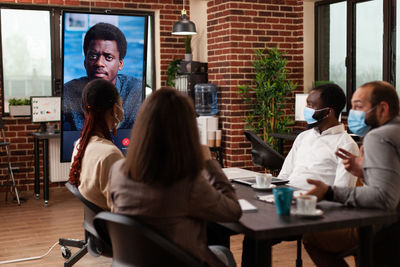 Business colleagues during video call at office